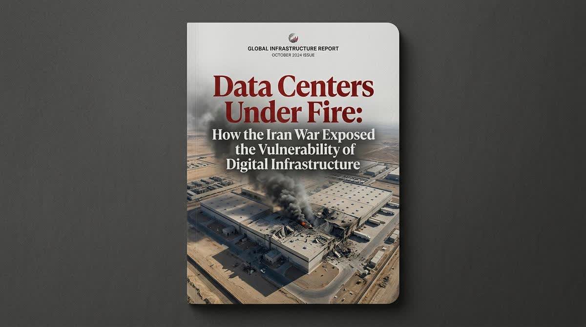 An aerial view of a damaged data center facility showing the aftermath of a drone strike, with smoke rising from the structure.